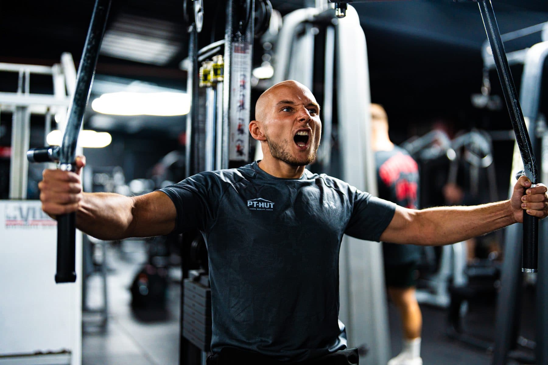 Daniel Marshall mid-set on a chest machine, shouting through the last rep
